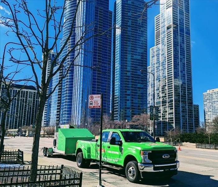 image of downtown Chicago with a green SERVPRO vehicle 